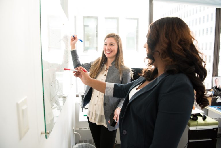 two women in front of dry erase board 1181533 scaled